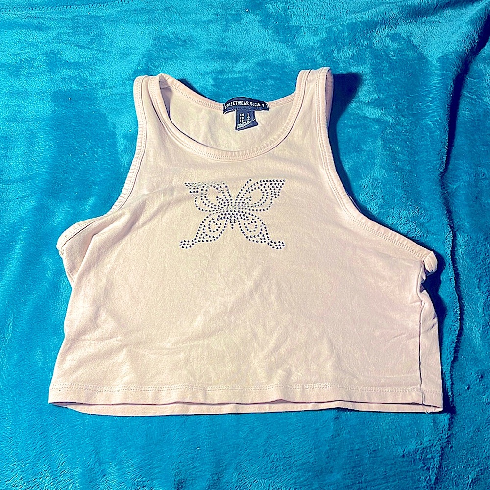 Light pink very cropped tank top, small butterfly print on it the front